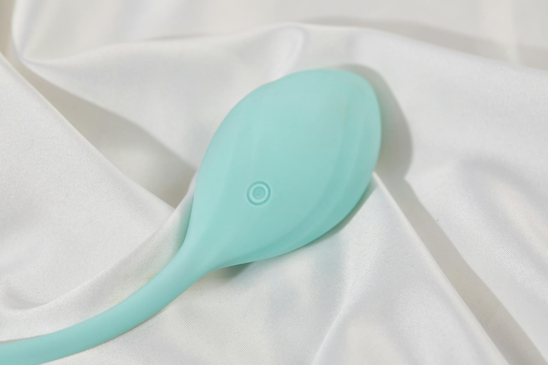 Hand holding a vibrator against a purple background, representing pleasure after hormonal shifts