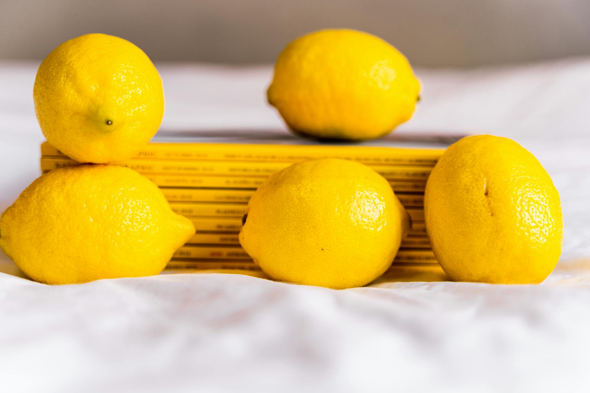 Fresh lemons and books on a white surface, symbolizing clarity and reconnection after conflict